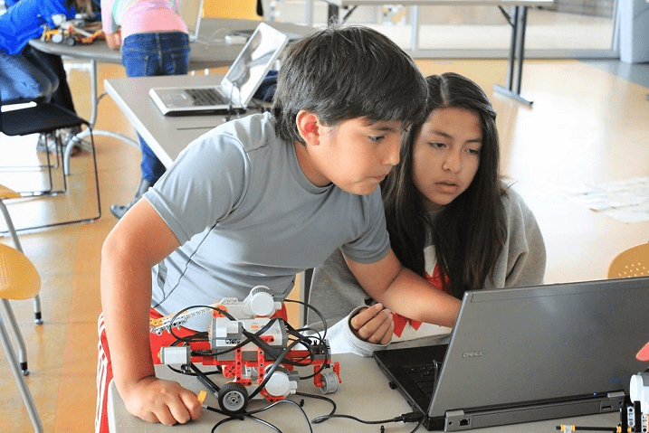 Students learning robotics in a modern lab
